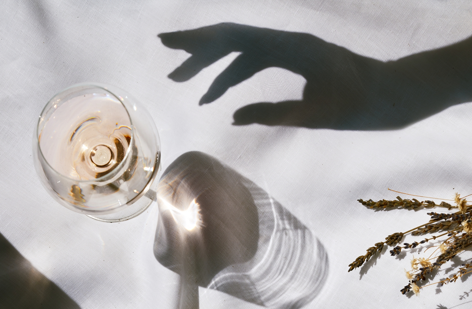 a-shadowy-hand-taking-a-glass-of-rose-wine-of-provence